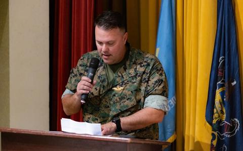 Photo Of U.S. Navy Lt. Charles Hall, the deputy group chaplain of Marine Aircraft Group (MAG) 36, prays for the success of Sgt. Maj. Enrique De Anda, the incoming sergeant major for Marine Aviation Logistics Squadron 36.