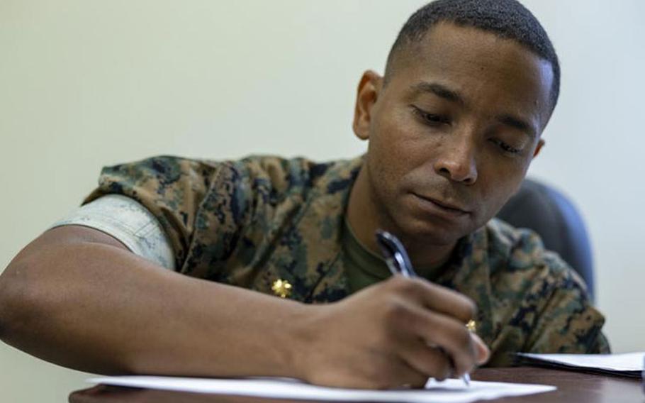 U.S. Marine Corps Maj. Phillip Tate, the company commander of Bravo Company, Headquarters and Support Battalion, Marine Corps Installations Pacific, takes notes on Camp Foster, Okinawa, Japan, June 9, 2022. Tate assumed command of Bravo Co. on May 25 and prioritizes knowing and understanding Marines’ needs. He also strives to lead his company to mission success with the highest standards of the Marine Corps. (U.S. Marine Corps photo by Lance Cpl. Jonathan Beauchamp)