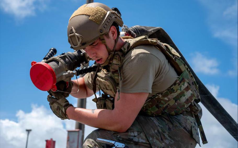 U.S. Air Force Airman 1st Class Ty Tavel, 18th Logistics Readiness Squadron fuels distribution operator, carries a hose during a forward area refueling point tryout at Kadena Air Base.