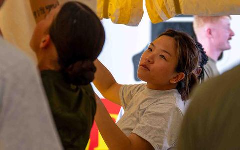Photo Of U.S. Air Force Airman 1st Class Ronan Zhou, 18th Civil Engineer Squadron emergency management personnel, sets up a hazardous material decontamination tent during a joint hazardous materials recertification course at Kadena Air Base, Japan.