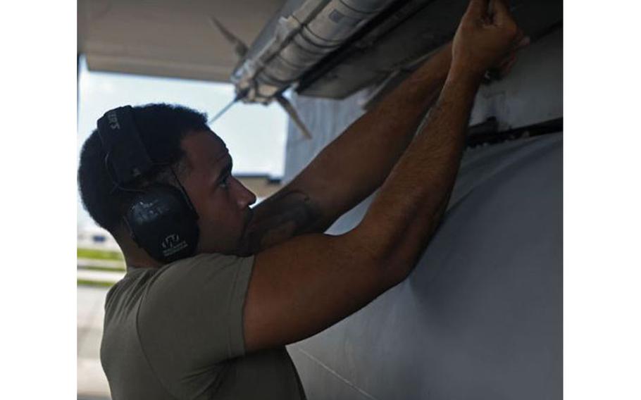 U.S. Air Force Staff Sgt. Jacob Wigfall, 44th Aircraft Maintenance Unit weapons load crew team chief, secures an AIM-9 Air-to-Air Missile onto an F-15C Eagle Oct. 30, 2020, at Kadena Air Base, Japan. Wigfall and his two teammates represented the 44th AMU in the 3rd Quarter’s Load Crew of the Quarter Competition between the 44th and 67th AMUs. (U.S. Air Force photo by Tech. Sgt. Benjamin Sutton)