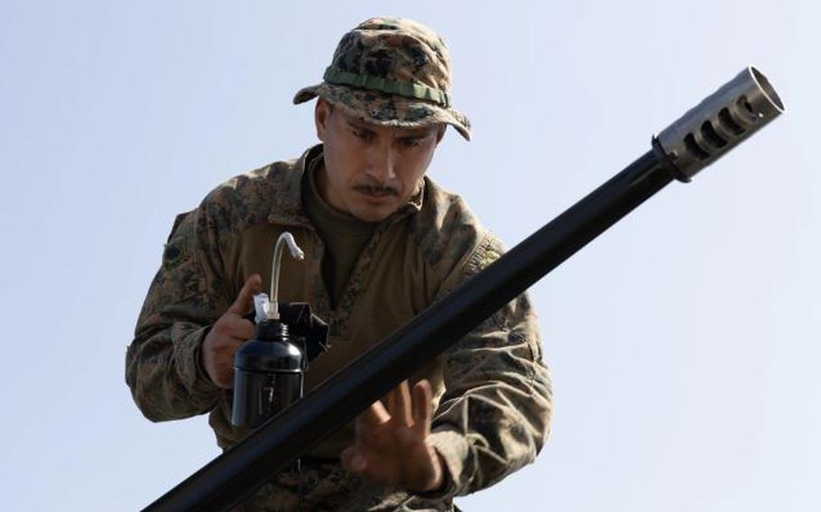 U.S. Marine Corps Sgt. Manuel Gomez, a light armored vehicle crewman with Battalion Landing Team 1/1, 31st Marine Expeditionary Unit, oils a 25mm barrel during an amphibious landing exercise, part of Iron Fist 24, at Camp Hansen, Okinawa, Japan, Mar. 12, 2024.