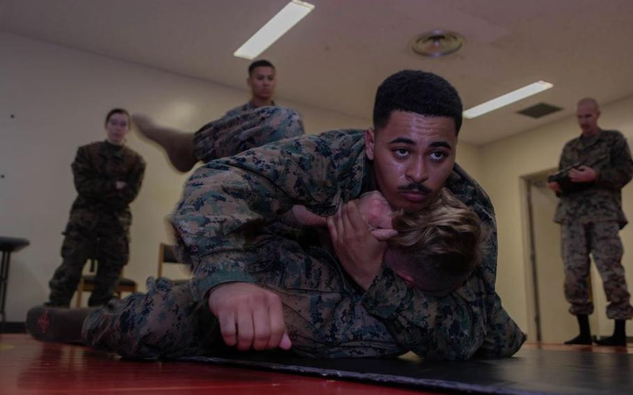 U.S. Marines Corps Cpl. Mohammed Saleh, a food service specialist, and Cpl. Jacksen Phifer, a ground electronics transmission systems maintainer, both with III Marine Expeditionary Force (III MEF), grapple during a Martial Arts Instructor (MAI) course on Camp Kinser, Okinawa, Japan, Jan. 23, 2025.