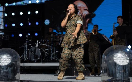 U.S. Marine Corps Cpl. Emily Figueroa, a vocalist with the III Marine Expeditionary Force Band, sings during the Camp Foster Festival on Camp Foster, Okinawa, Japan, July 6, 2024. 
