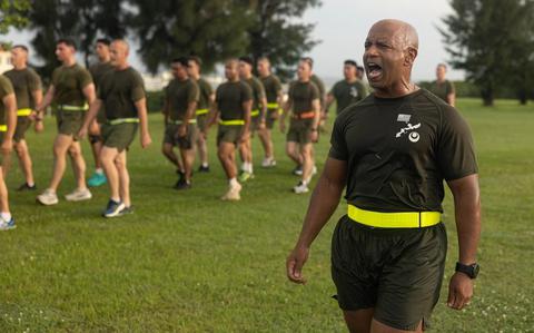 Photo Of U.S. Marine Corps Sgt. Maj. Dennis R. Turner Jr., sergeant major of 3rd Marine Logistics Group, marches a formation after completing a motivational run at Camp Kinser, Okinawa.