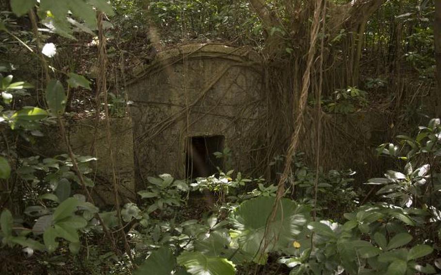 A photo of an open turtle-back tomb on Marine Corps Air Station Futenma, Okinawa, Japan. These tombs are used to hold the remains of families. When they are closed, the tomb is still in use. When open, the family spirits are released.