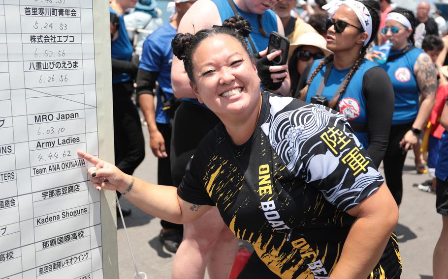 Yuuki Dugas-Bird of the Army’s Dragon Boat team points at the time board, proudly showing their 0.17-second victory over the Navy Ladies Dragon Boat team.