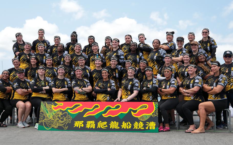 The Army Ladies Dragon Boat Team takes a group picture, beaming with pride and joy after their win at the Dragon Boat race in Nahashin Port, Okinawa.