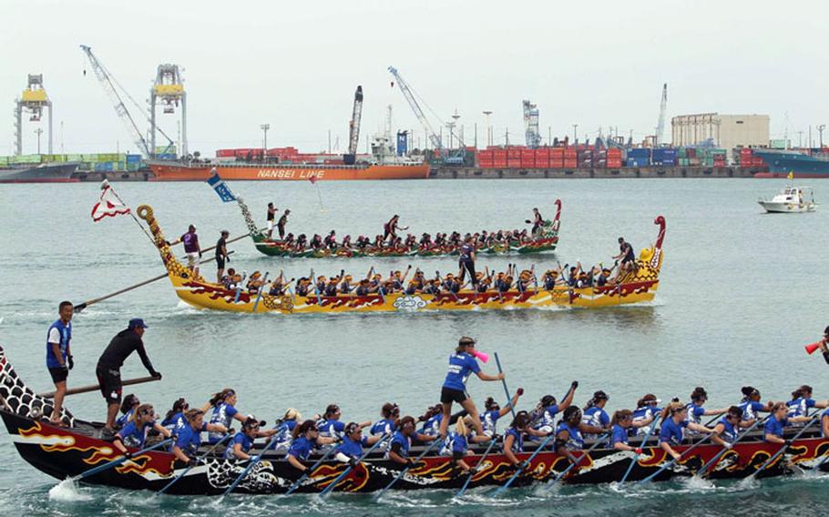 U.S. Army photo of rowers in Naha Port aboard dragon-shaped boats for the popular Naha Dragon Boat Races.