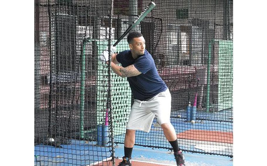 Kevin Vega, from Kadena Air Base, swings at a fastball at Chatan Sports Center.