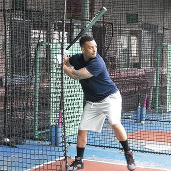 Kevin Vega, from Kadena Air Base, swings at a fastball at Chatan Sports Center.