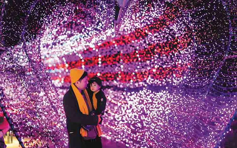 father and child enjoying Christmas Fantasy Illuminations at Okinawa Zoo & Museum